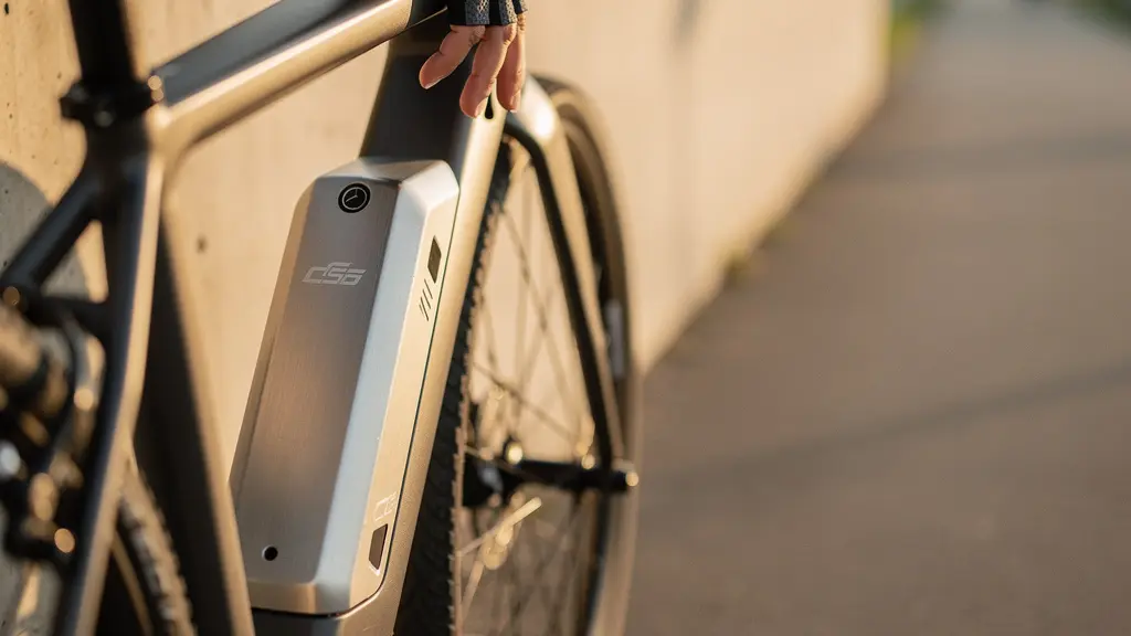 Close-up of an e-bike lithium battery pack integrated into a sleek bicycle frame, with soft natural light highlighting its metallic surface and connector details.