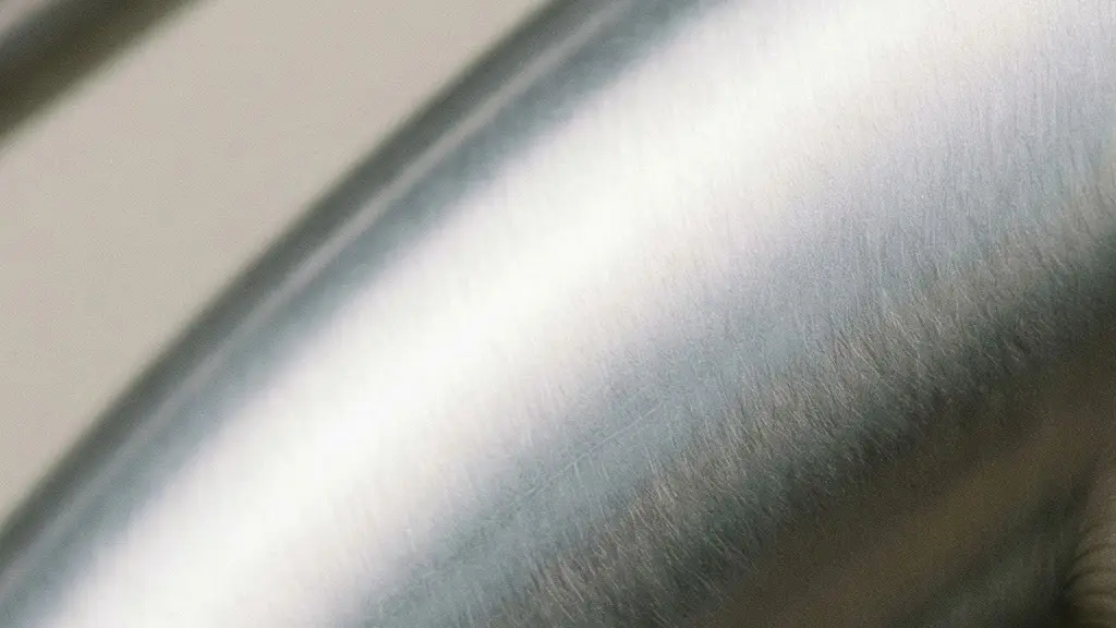 Extreme close-up of a polished hydroformed aluminum bicycle frame tube showing smooth contours and welded joint detail