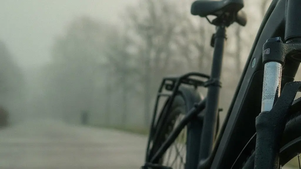 A bicycle front suspension fork photographed in a minimalist setting with soft morning light highlighting its mechanical detail