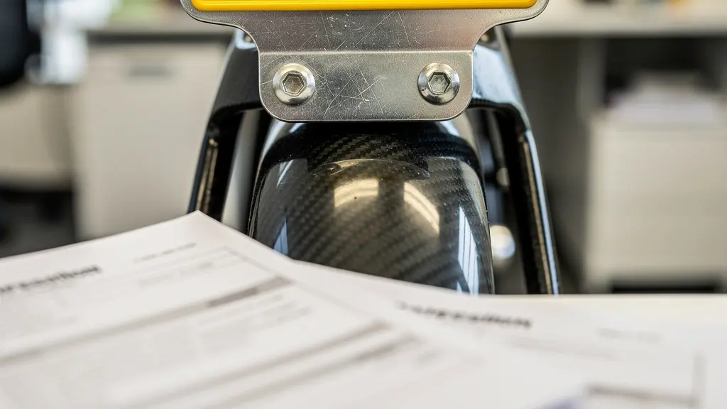 Close-up of speed pedelec license plate and registration documents arranged on desk